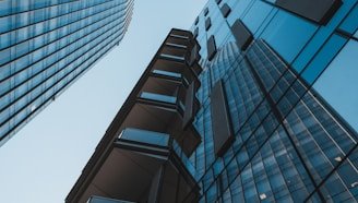 blue glass walled high rise building